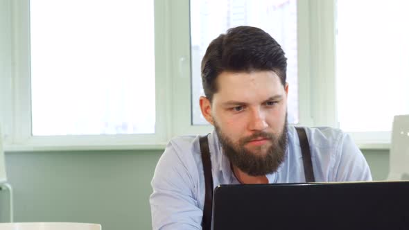 Architect Finishes His Work on Laptop