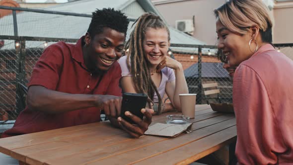 Diverse Friends Having Fun at Outdoor Rooftop Cafe