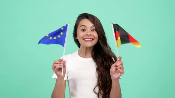 Kid with Happy Face Waving European Union and German Flag Selective Focus Football Fan