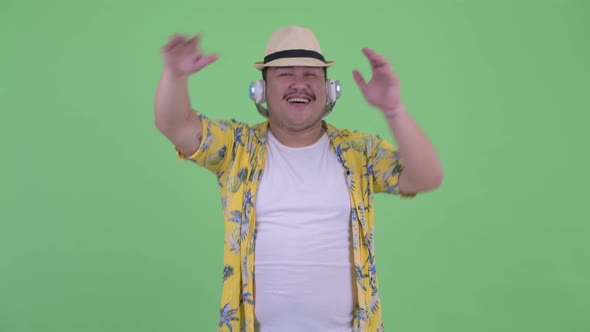 Happy Young Overweight Asian Tourist Man As Dj Dancing