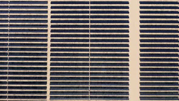 Cinematic  Straight Top Down Aerial View on Large Solar Power Fields in Desert alt