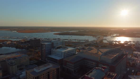 The sun sets over downtown Charleston along Ashley River