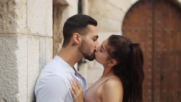 Happy Ethnic Couple Touching Noses While Talking in Town