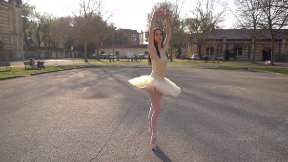 Young Ballerina Dancing In Courtyard