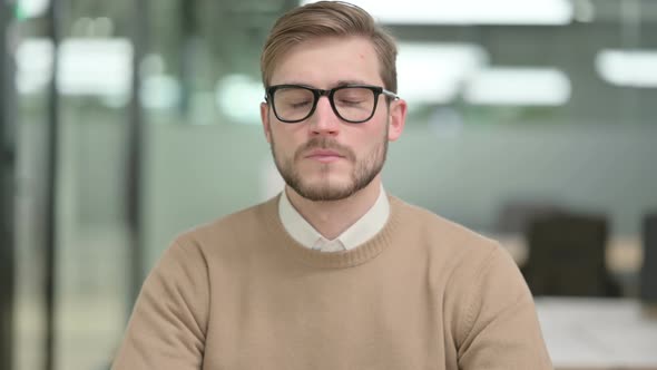 Serious Young Creative Man Looking at the Camera