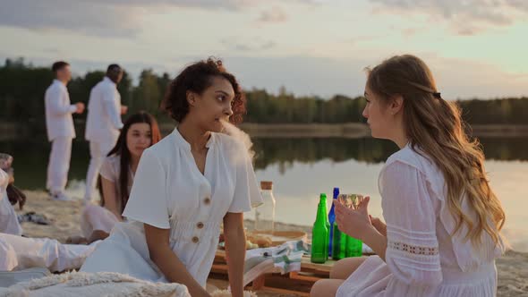 Young People Chat at a Sunset Beach Party