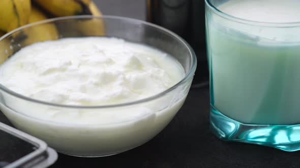 Fresh Yogurt in a Bowl  Banana Blue Berry and Milk on Table