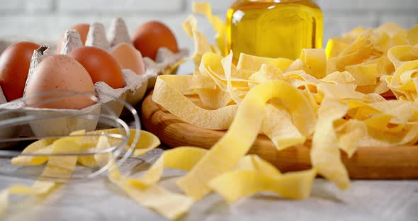 Dry Fettuccine Pasta on a Cutting Board Rotates Slowly. 