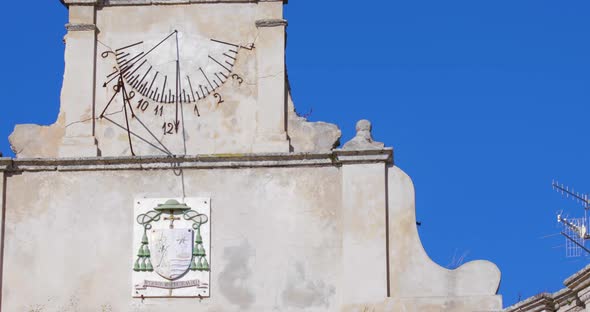 Ancient sundial on a stone portal