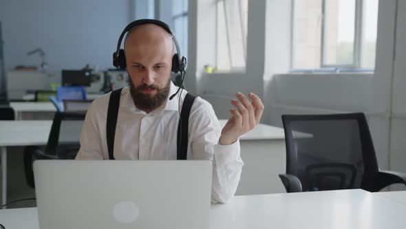 Serious Man Wears Headphone and Talk Online