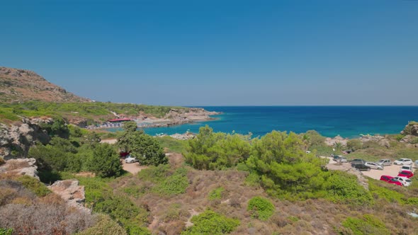 Beautiful view of mountain landscape with beach area of hotel, equipped with sun loungers.