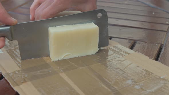 Cutting homemade olive oil and coconut bar soap into bars