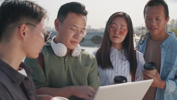 Asian Colleagues with Laptop Outdoors