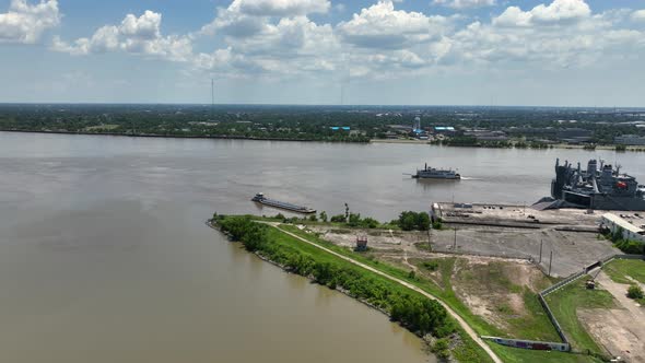 Aerial approach towards the Busy Mississippi River near an abandoned military support facility