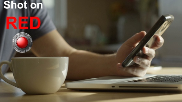 Freelancer Having Breakfast With A Cup Of Coffee Notebook And A Phone