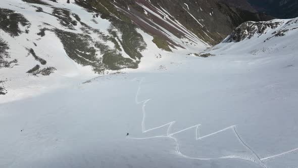 Professional Skier Ride Freeride Backcountry on a Snowy Slope on a Sunny Day