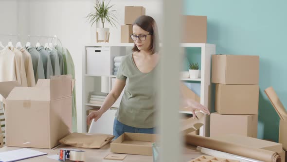 Online Shop Worker Wrapping Good for Sending