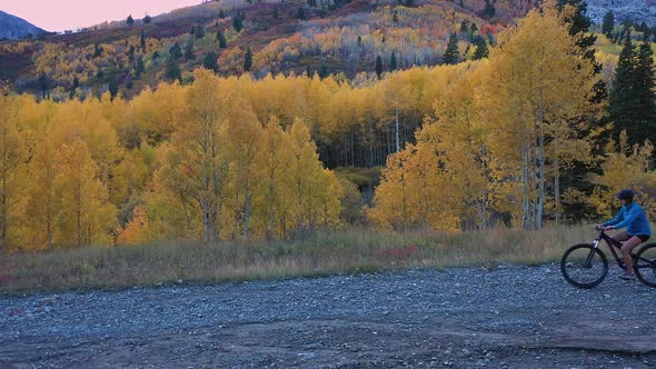Color autumn scene in the Utah mountains with people mountain biking