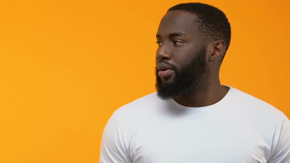 Excited Black Male Pointing at Bright Background, Place for Your Text, Surprise