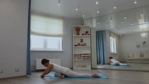 Young Woman Practicing Yoga in Studio