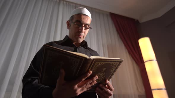 Muslim man reading quran.