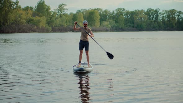 Man Sup Surfing .Stand up Paddling Surfboard. Inflatable Board For Rowing. Travelling Water Tourism.