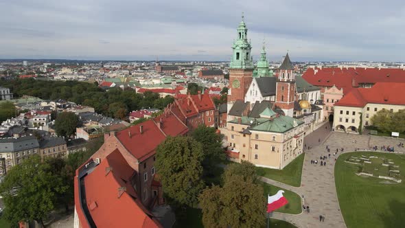 Aerial drone view of the Wawel Royal Castle, the cathedral and a courtyard with walking people in su