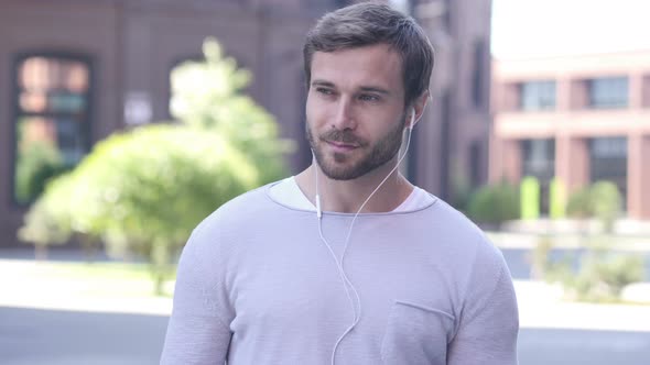 Handsome Man Listening Music on Smartphone