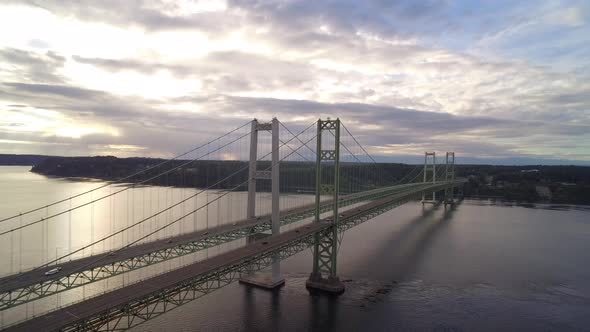 Rising wide drone shot of Tacoma Narrows Bridge at sunrise, circa 2015.