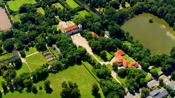 Beautiful avenue of trees of Nieborow Palace, a Baroque style residence in Poland. Colourful foliage