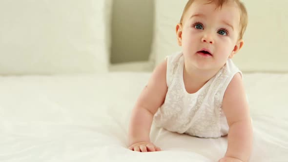 Cute smiling baby girl on bed