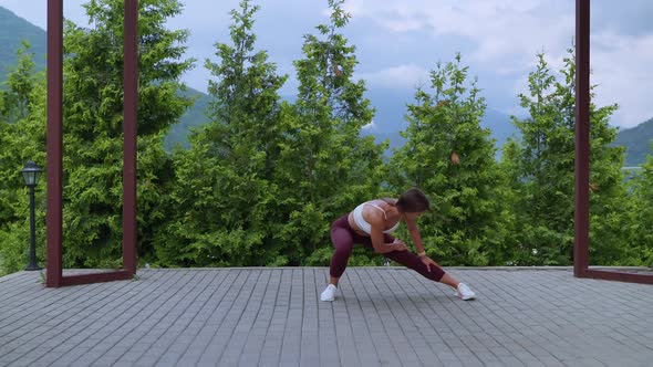 Stretching Workout in Park Woman is Training in Nature Warming Before Fitness Class