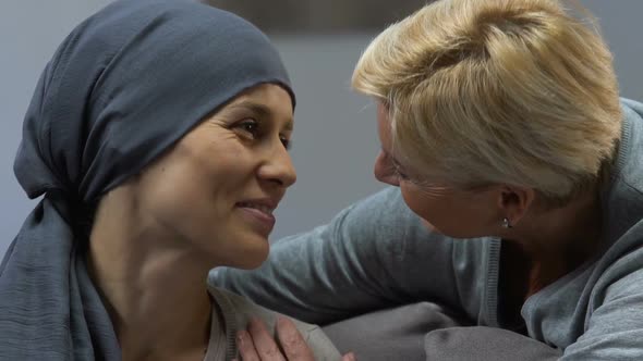 Mother Kissing Loving Daughter With Cancer Supporting During Chemotherapy