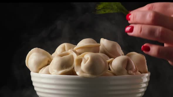 Dill is Placed in a Large Plate of Dumplings