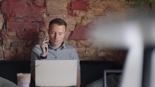 Thoughtful Serious Young Man Student Writer Sit at Home Office Desk with Laptop Thinking of