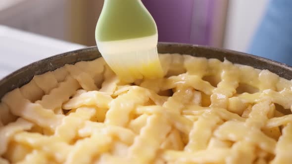 Apple Pie Cake Preparation Series  Woman Brushing Pie with Beaten Eggs Before to Put Them in Oven