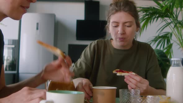 Lesbian Parents Having Breakfast with Son at Home