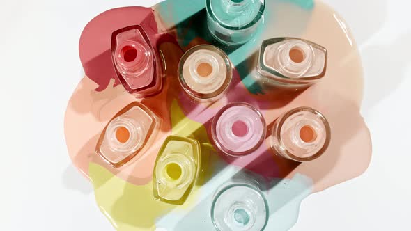 Multicolored Nail Polish Samples Spilled on White Background Isolated