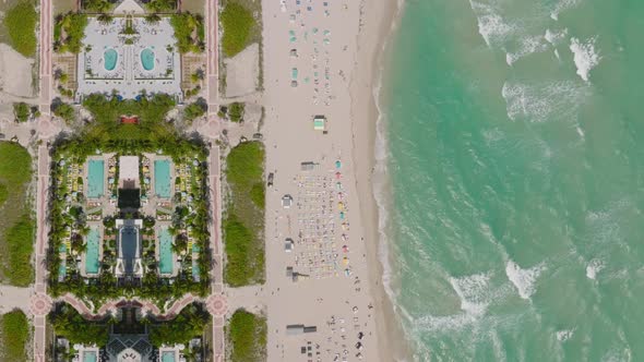 Top Down Footage of Waves Washing Sand Beach in Tropical Vacation Resort
