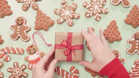 Traditional home made gingerbread cookies as food gifts on blue background with Christmas light.