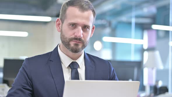 Portrait of Cheerful Businessman Smiling and Looking at Camera