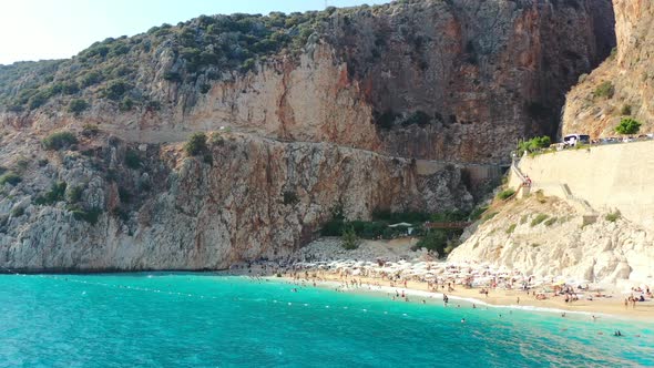 Aerial drone flying low near the turquoise blue Mediterranean Sea. During a sunset afternoon at Kapu