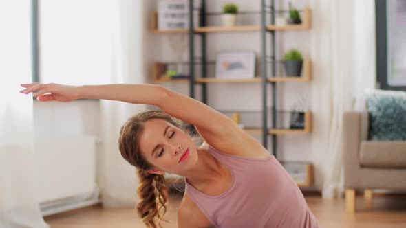 Young Woman Doing Yoga Exercise at Home