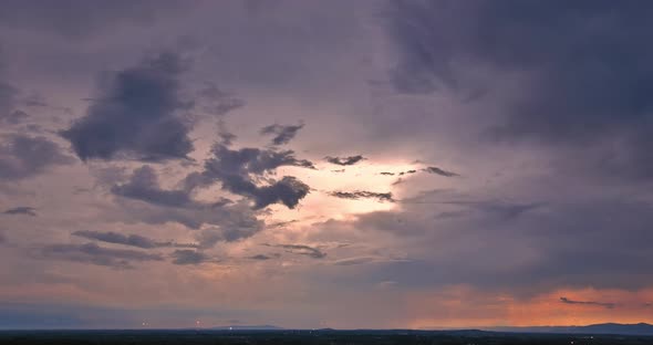 A Brilliant Orange Sunset is Complemented By a Dramatic Lightning Strike