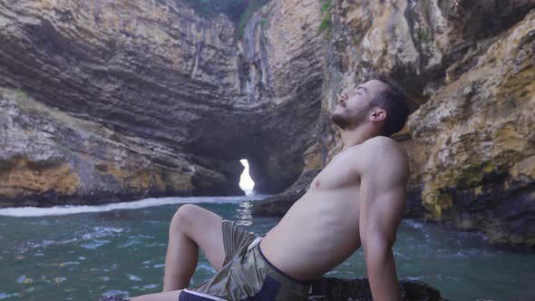 Muscular and fit young man on vacation at sea.