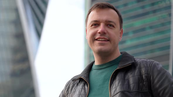 Millennial Excited Man Celebrating His Success Standing Outdoors in Urban Area