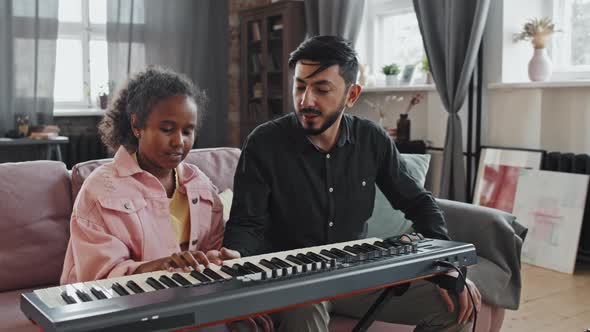 Girl Having Music Lesson with Tutor