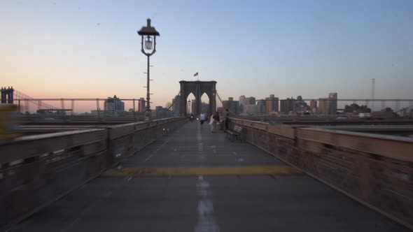 Hyper Lapse Over Empty Brooklyn Bridge at Sunrise with Few People in Times of Coronavirus Covid 19