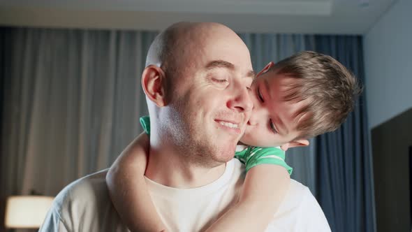 Portrait of an Affectionate Happy Cute Child Charming Kid a Son Hugging and Kissing His Father