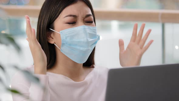 Confused Asian Woman in Medical Mask Reading Bad News About Covid19 Pandemic Receive Refuse Email on